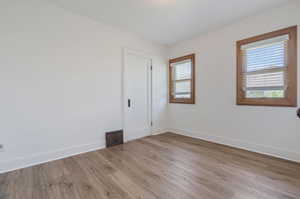 Unfurnished room with hardwood / wood-style floors