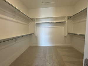 primary closet  - image is of furnished model home - actual finishes may differ - furnishings not included