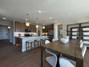 kitchen and dining  - image is of furnished model home - actual finishes may differ - furnishings not included