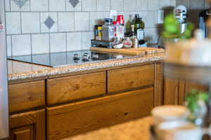 Bar with light stone countertops and backsplash