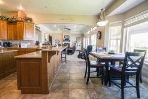 Dining room featuring sink, ceiling fan, and tile floors