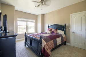 Bedroom featuring ceiling fan and light colored carpet