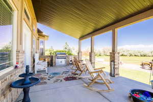 View of terrace with an outdoor kitchen and area for grilling