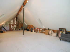 A-frame attic space with stubbed plumbing and exposed structural steel support columns