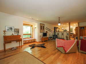 Large basement living room with wood floors and natural light