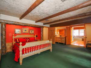 Primary suite bedroom with sun-drenched entry to suite bath