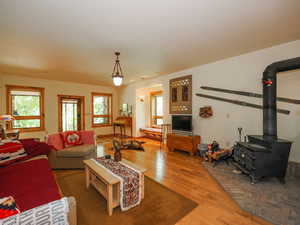 Basement living room with engineered wood floors and ample windows, facing Western, separate entrance