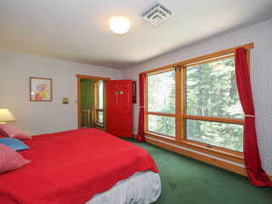 Bedroom 4 featuring Eastern wooded views and large windows