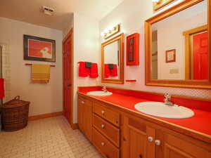 Bedroom floor shared bath featuring double vanity