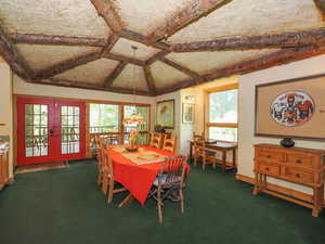 Dining room featuring natural light, coved plaster & straw ceiling with log pattern