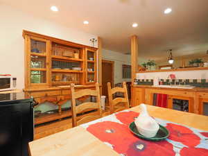 Full basement kitchen with dining area and built-in hutch