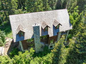 North side with grand river stone chimney, shake roof, all 4 floors above ground