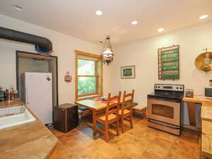 Full basement kitchen with sink and range