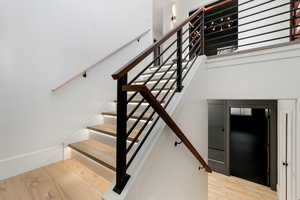 Staircase featuring light hardwood / wood-style flooring