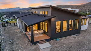 Back house at dusk featuring a mountain view