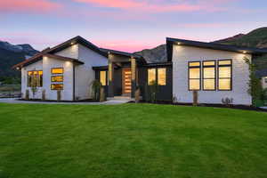 View of front of house featuring a yard and a mountain view