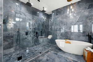 Bathroom featuring tile walls, tile flooring, and shower with separate bathtub