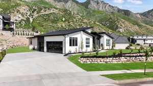 View of front of property with a garage and a mountain view