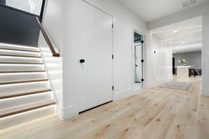 Hallway with light hardwood / wood-style floors