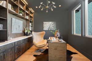 Home office featuring custom book shelves and chandelier