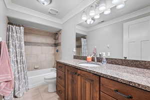 Full bathroom with tile flooring, vanity, toilet, and shower / tub combo