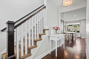 Staircase with dark wood-type flooring