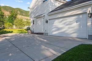 View of home's exterior featuring a garage and a mountain view