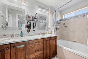 Owner's Bathroom with shower / bathtub combination with curtain and dual vanity