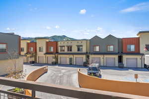 View of front of property with a garage and a mountain view