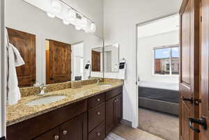 Bathroom featuring tile floors, dual sinks, and large vanity