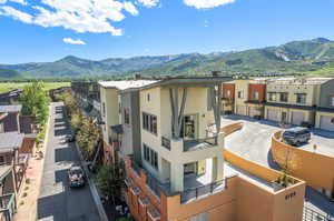 View of building exterior featuring a garage and a mountain view