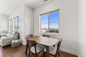 Dining area with plenty of natural light and hardwood / wood-style flooring