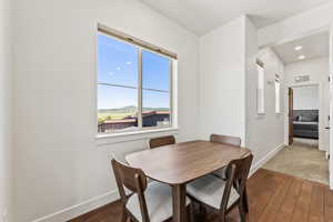 Carpeted dining area featuring plenty of natural light