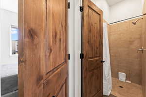 Bathroom featuring curtained shower