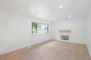 Unfurnished living room featuring a fireplace and wood-type flooring