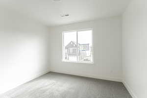 Unfurnished room with carpet flooring