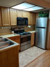 Kitchen featuring sink, light hardwood / wood-style flooring, and stainless steel appliances