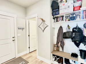 Mudroom with light hardwood / wood-style flooring