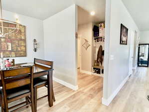 Dining space with light hardwood / wood-style floors and a textured ceiling