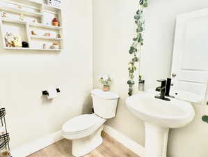 Bathroom featuring toilet and hardwood / wood-style flooring