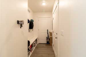 Mudroom featuring light LVP flooring right off of the garage