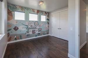 Spare room with dark wood-type flooring