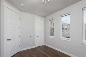 Empty room with dark hardwood / wood-style floors