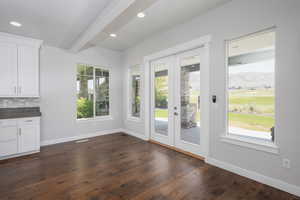 Entryway with a healthy amount of sunlight, dark hardwood / wood-style floors, and a mountain view