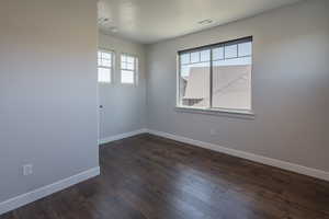 Unfurnished room with dark hardwood / wood-style floors