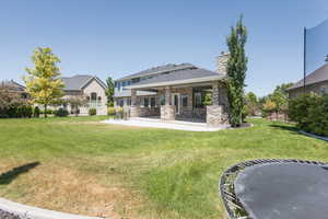 Back of house featuring a patio and a yard