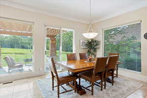 Tiled dining space with crown molding