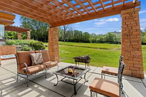 View of patio featuring an outdoor fire pit and a pergola