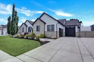 View of front of house with a garage and a front yard