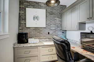 Home office with brick wall